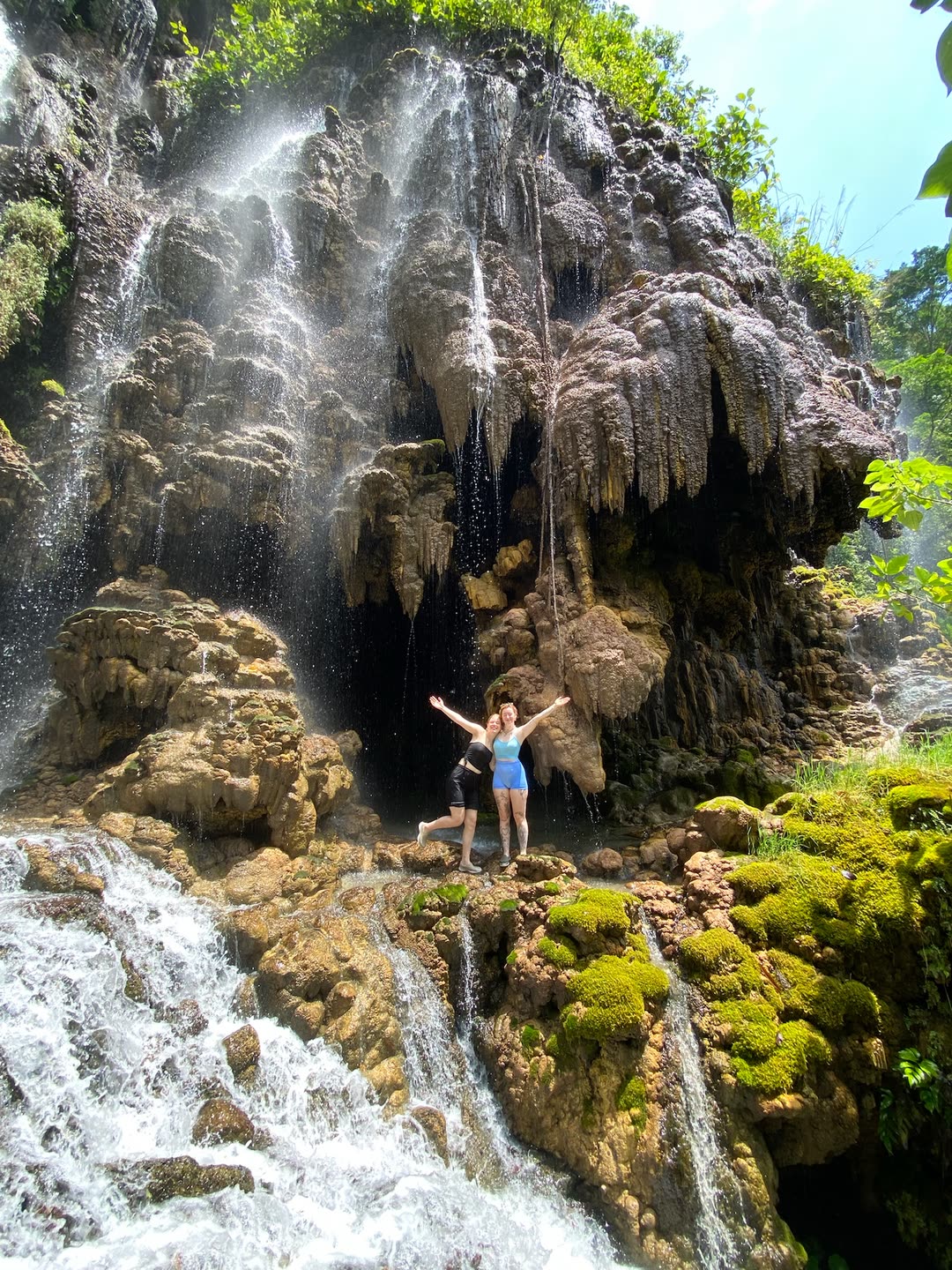 Couple at a hidden limestone waterfall near Yogyakarta on a private Florish Tour day trip