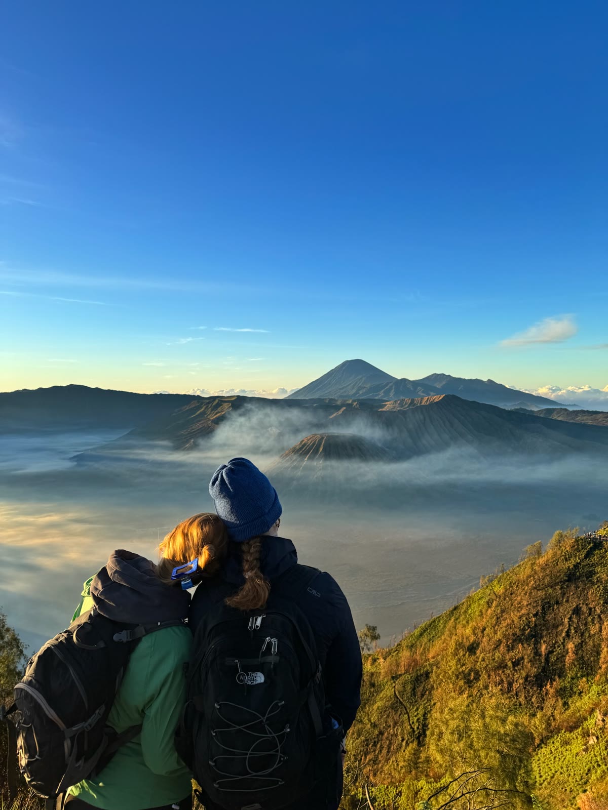 Couple watching Mount Bromo sunrise above the sea of clouds on a private tour from Yogyakarta